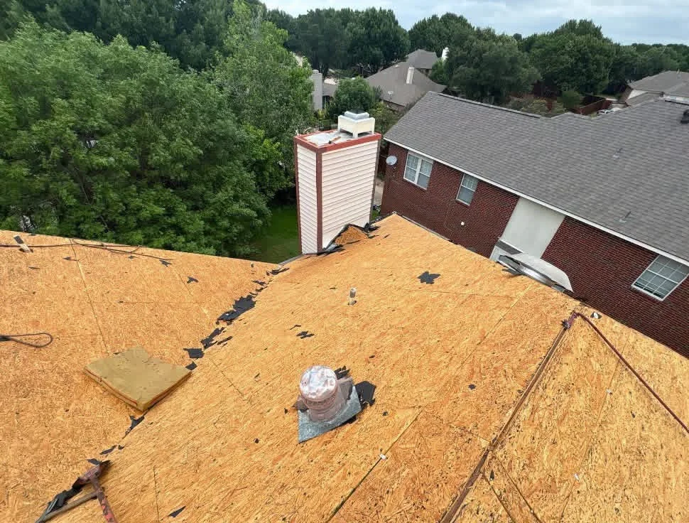 OSB roof decking with ice and water shield underlayment and chimney flashing installation