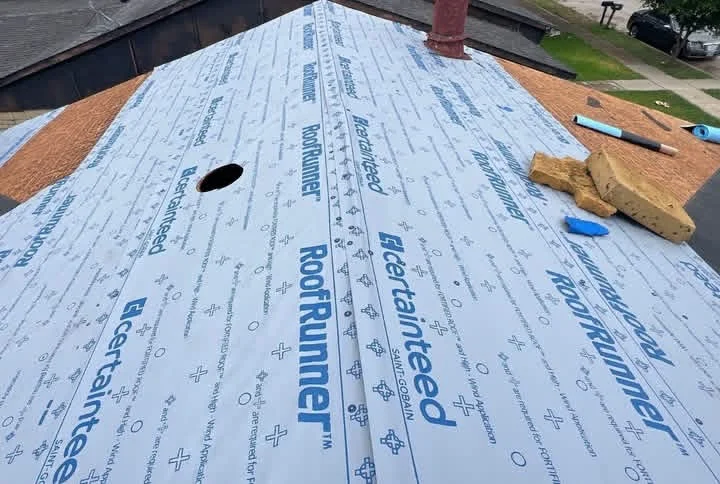 Plywood roof decking with synthetic underlayment and roof penetration opening