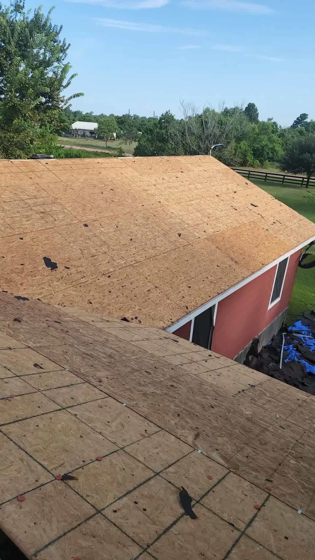 OSB roof sheathing with roofing felt underlayment and fasteners installed on residential roof