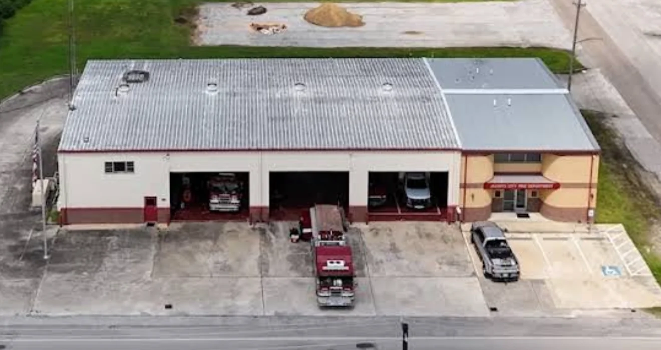 Aerial view of commercial building with new corrugated metal roof installation and standing seams