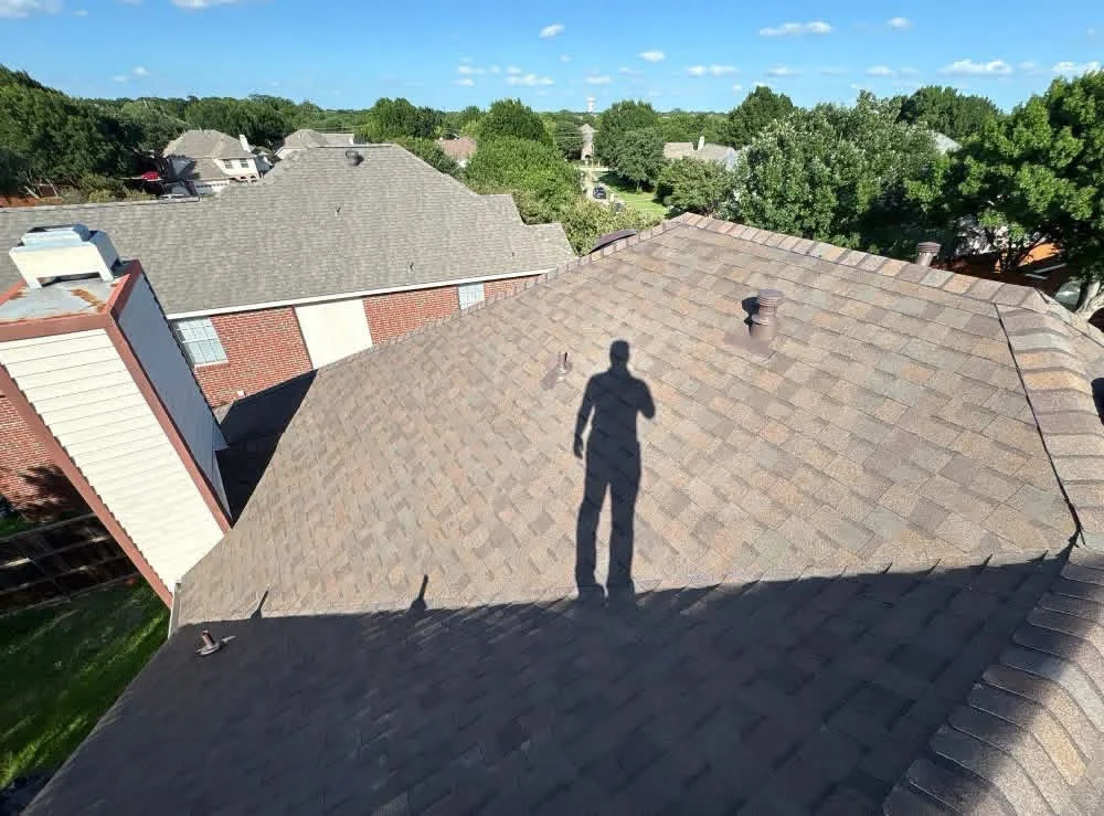 Newly installed architectural shingle roof with brown dimensional shingles and proper flashing details