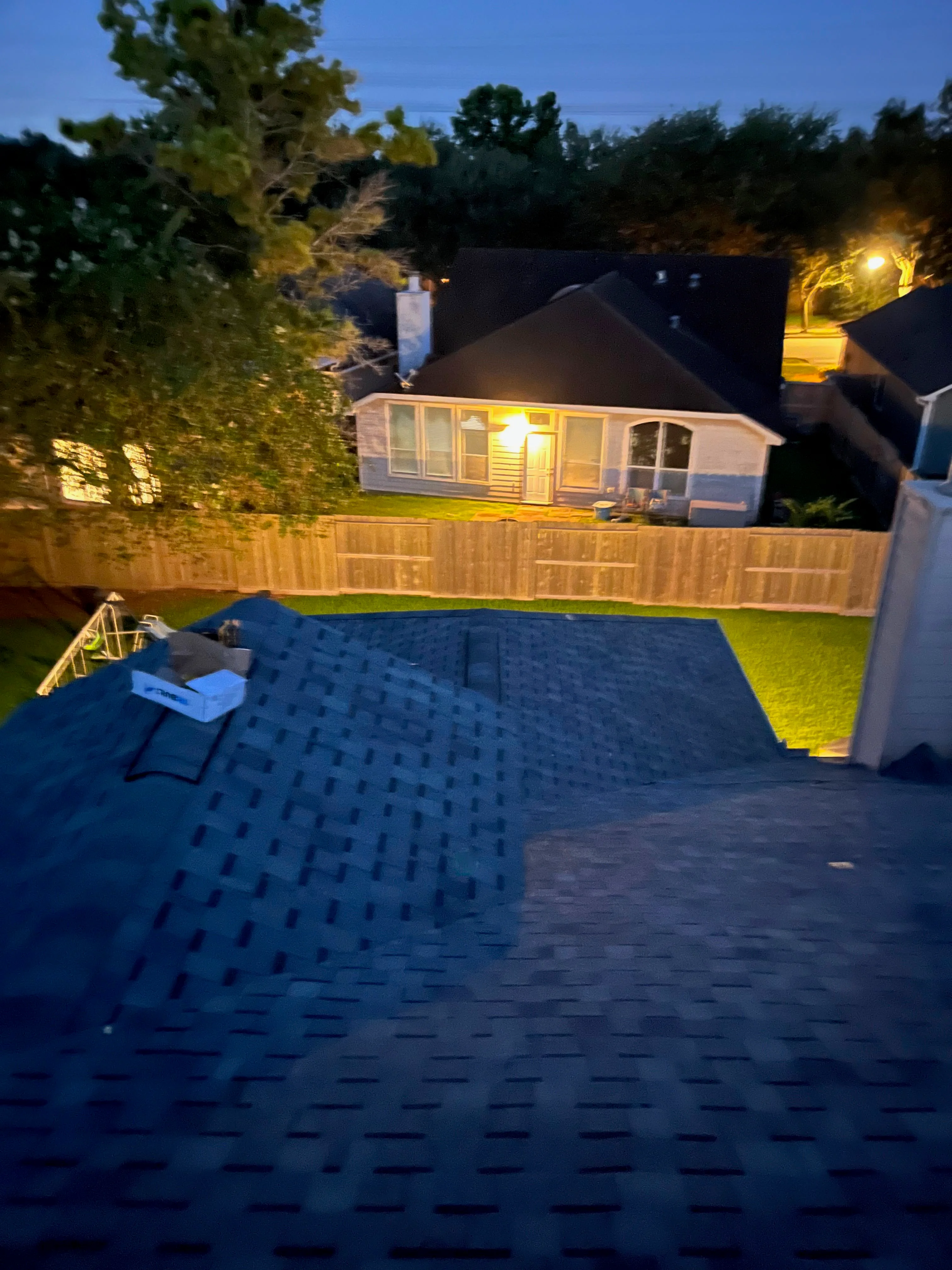 Dark architectural shingle roof installation with dimensional texture and clean lines