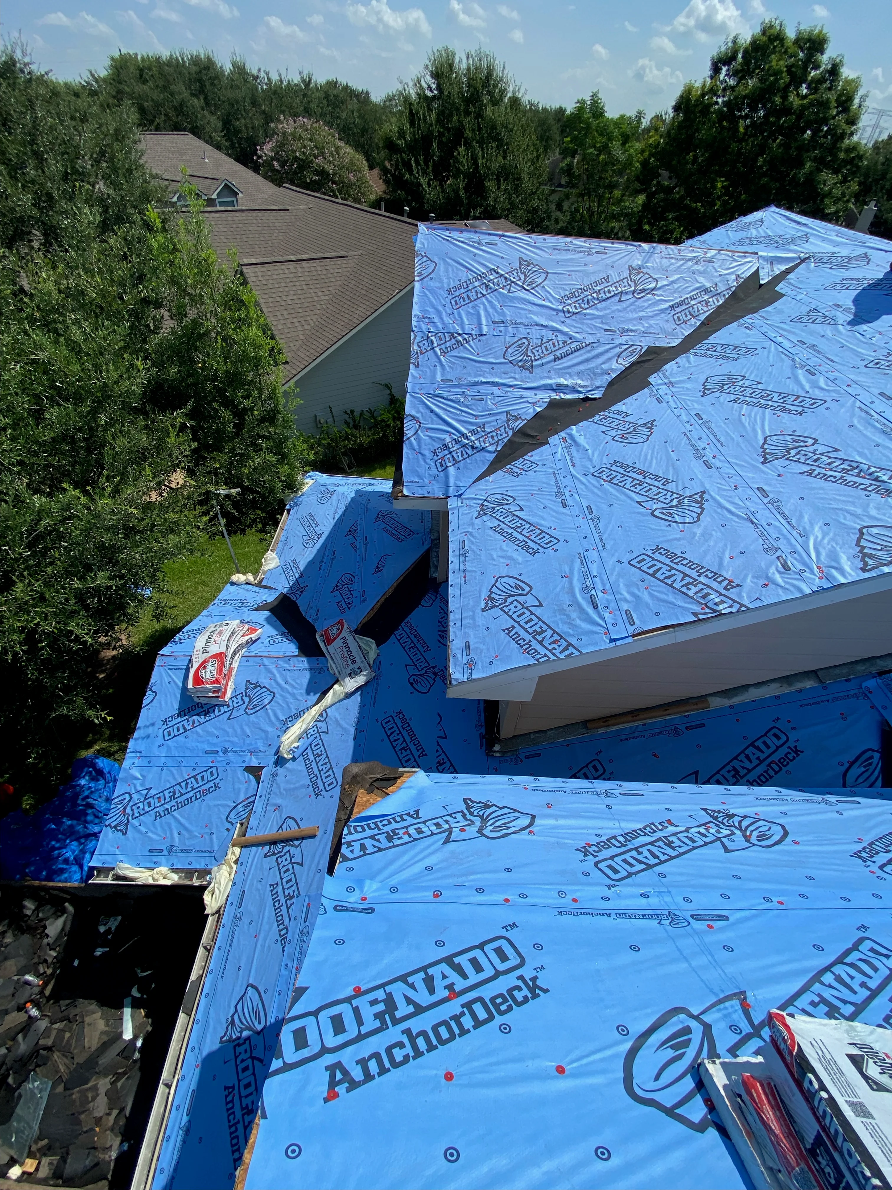 Blue synthetic roof underlayment with anchor deck installed on residential roof framing